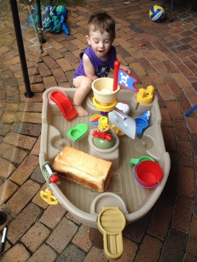 T plays with a loaf of bread in the pirate ship.  Because that's where bread goes apparently.
